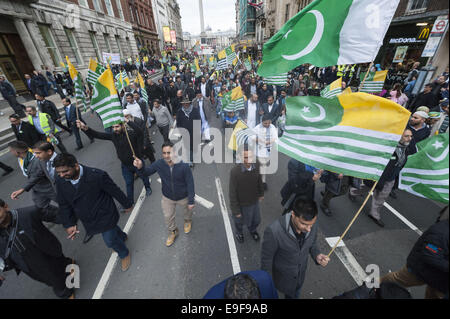 London, UK. 26th Oct, 2014. Several hundred pro-kashmiri supporters take part in the so-called 'Million March'' from Trafalgar Square to Downing Street. The date of the march, October 26, has been highlighted as significant for pro-Pakistan groups as it was on this date in 1947 that the last ruler of the state of Jammu and Kashmir acceded to India. Pictured: Pro-Kashmiri supporters block traffic as they march down Whitehall. © Lee Thomas/ZUMA Wire/Alamy Live News Stock Photo