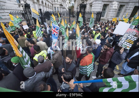 London, UK. 26th Oct, 2014. Several hundred pro-kashmiri supporters take part in the so-called 'Million March'' from Trafalgar Square to Downing Street. The date of the march, October 26, has been highlighted as significant for pro-Pakistan groups as it was on this date in 1947 that the last ruler of the state of Jammu and Kashmir acceded to India. Pictured: Pro-Kashmiri supporters surround the entrance to Downing Street. © Lee Thomas/ZUMA Wire/Alamy Live News Stock Photo