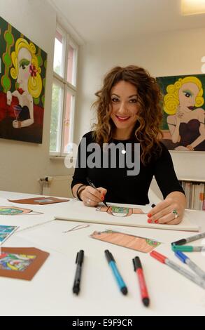 Exclusive: The artist and designer Paola Ezra crugnale paints works of art that are incorporated on handbags and wallets of the company 'Cuore'. The handbags are made in a combination of art and craft. The painted on canvas works by the artist are digitized and printed on the finest Vachette leather. Germany, 21st. October, Photo: Frank May Stock Photo