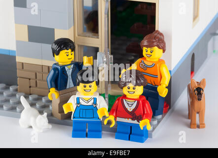 Tambov, Russian Federation - January 12, 2014 Happy LEGO family standing near his home with pets. Stock Photo