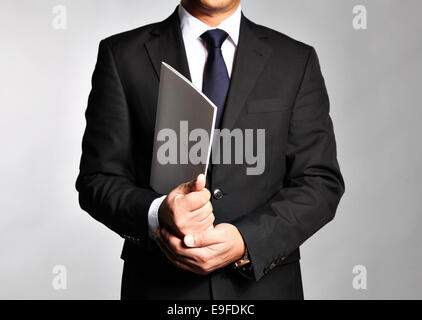 Businessman holds a booklet Stock Photo