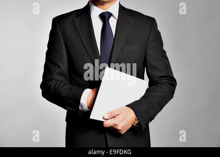 Businessman holds a booklet Stock Photo