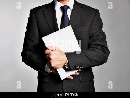 Businessman holds a booklet Stock Photo