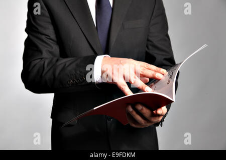 Businessman holds a booklet Stock Photo