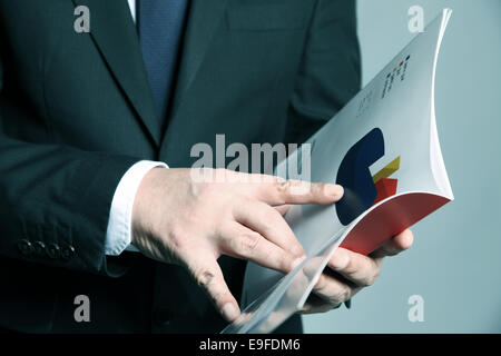 Businessman holds a booklet Stock Photo