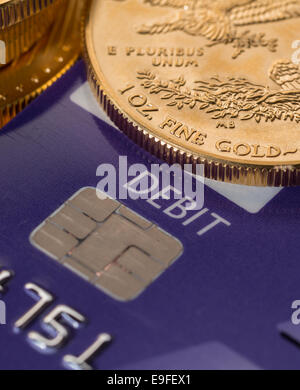 Gold coins on chip and pin debit card Stock Photo