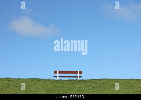 Bench on a dike at the North Sea Stock Photo