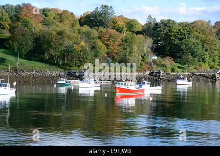 many small fishing boats docked in the Rockport Marine Harbor near Camden Maine in autumn Stock Photo