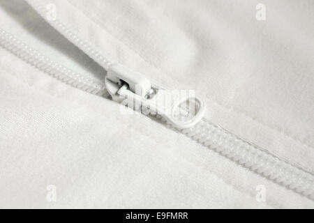 Closeup of zipper in white cloth Stock Photo