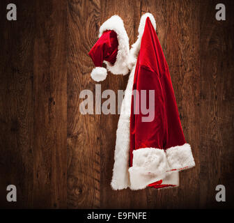 Santa costume hanging on a wooden wall shot with a tilt and a shift lens Stock Photo