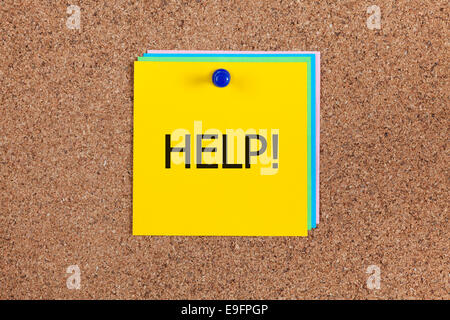 Yellow note with word "Help!" on cork board (bulletin board). Stock Photo