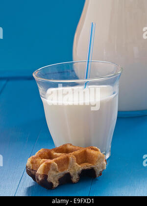 Milk in a jug before blue background Stock Photo