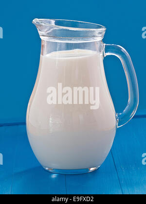 Milk in a jug before blue background Stock Photo