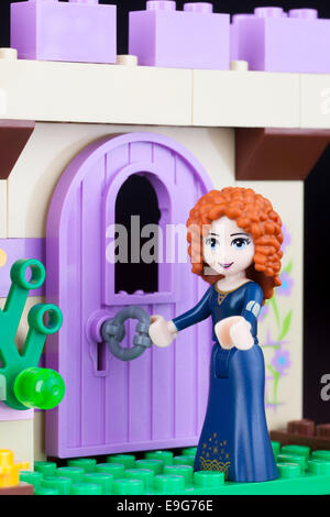 Tambov, Russian Federation -April 30, 2014 LEGO Disney Princess Merida minifigure open castle's door. Studio shot. Stock Photo