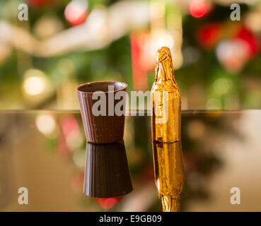 Miniature liqueur bottle by chocolate cup Stock Photo