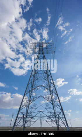 Centered Electric tower over blue sky and clouds, vertical composition Stock Photo