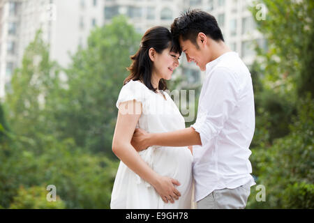 Pregnant woman and her husband embracing Stock Photo