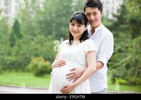 Young man embracing pregnant wife Stock Photo