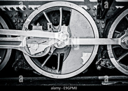 Closeup view of steam locomotive wheels, drives, rods, links and other mechanical details. Black and white photography Stock Photo