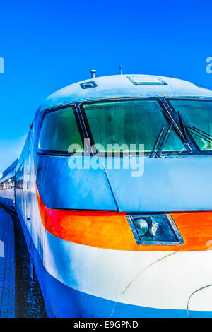 Closeup frontal view of an old electric high-speed locomotive against the background of clear blue sky Stock Photo