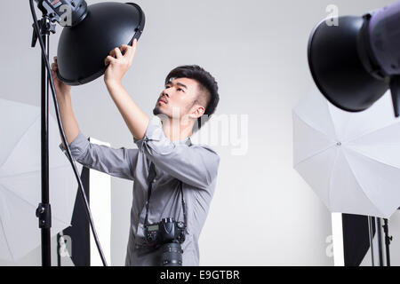 Photographer adjusting radar dome in studio Stock Photo