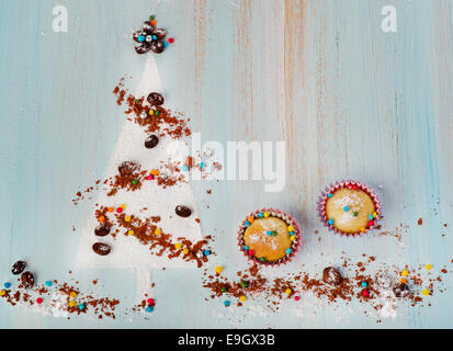 Cupcakes  and   sweet christmas tree  on wooden background Stock Photo