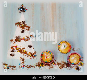 Cupcakes  and   sweet christmas tree  on wooden background Stock Photo