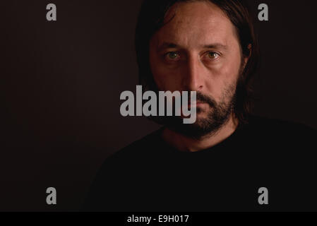 Adult man with beard, low key portrait Stock Photo