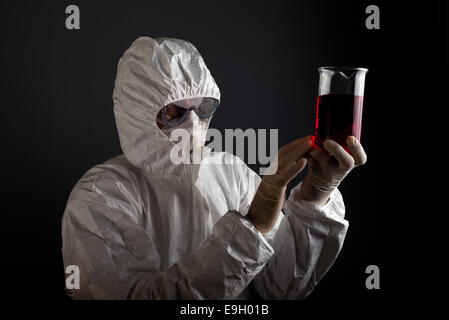 Man in medical laboratory examining blood sample. Stock Photo