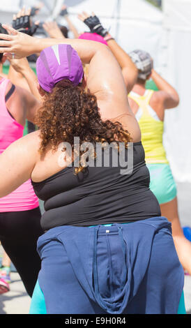 Large woman at outdoors Zumba aerobics exercise class in Spain Stock Photo