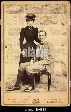 This portrait shows Queen Maud and King Haakon VII of Norway, captured in a formal cabinet card photograph. Taken by W. & D. Downey, it depicts the royal couple in their regal attire, representing Norwegian monarchy during the early 20th century. Stock Photo