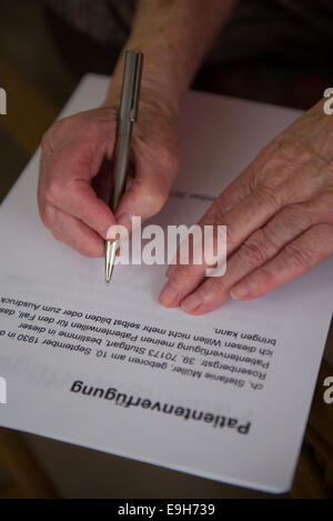 Hands of a 82-year-old woman signing a living will, Germany Stock Photo