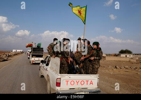 Kurdish People's Protection Unit (YPG) fighters riding an open-backed Toyota pickup truck in Al Hasakah or Hassakeh in northern Syria Stock Photo