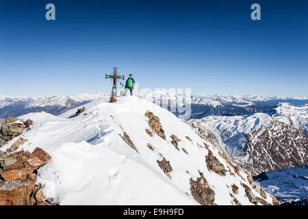 Mountaineer on the summit of Mt Penser Weißhorn, Sarntal Alps, Sarn Valley, South Tyrol, Trentino-Alto Adige, Italy Stock Photo
