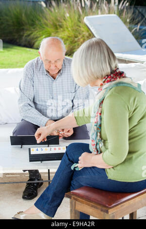 Senior people playing rummikub game together in nursing home Stock ...
