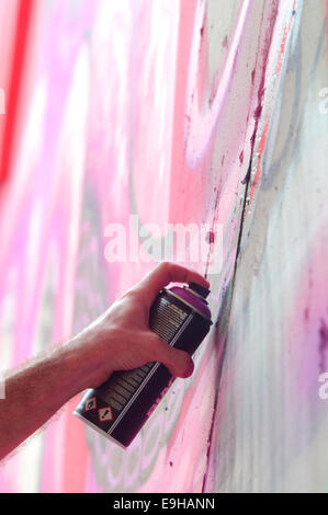 Hand Holding a Spray Can, Graffiti Artist at the Wall Stock Photo - Alamy