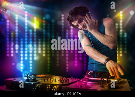 Dj playing songs in a disco with light show Stock Photo