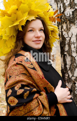 The pregnant girl in autumn park Stock Photo