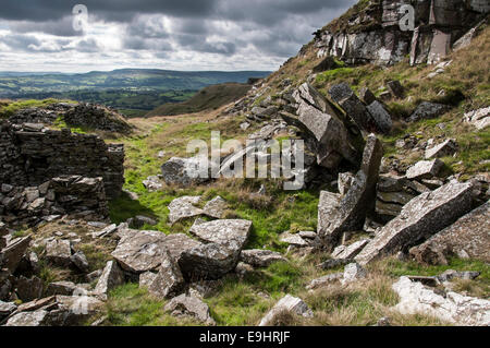 Cracken edge quarries near Chinley in Derbyshire. Moody lighting of high contrast. Gritstone rocks. Stock Photo