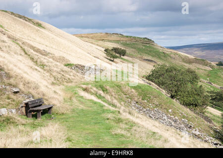 Cracken edge quarries near Chinley in Derbyshire. A bench beside the path to sit and admire the view. Stock Photo