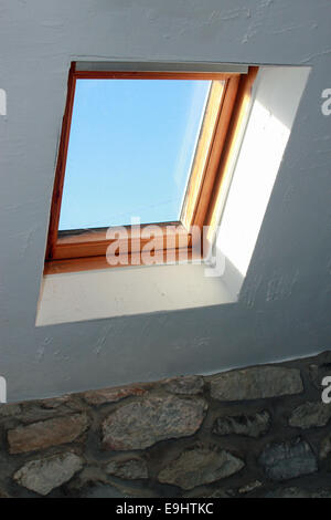 Skylight in a stone country property showing a clear blue sky Stock Photo