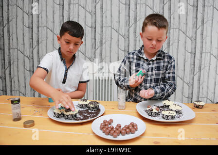 Children decorating cakes Stock Photo