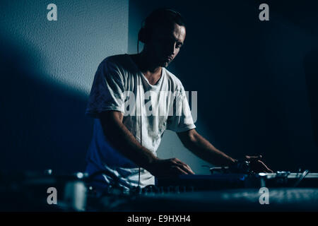 Male dj at work in night club. Shallow depth of field Stock Photo