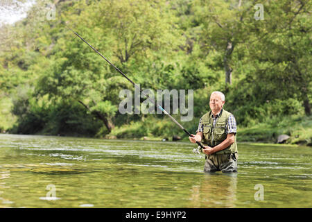 Fisherman fighting with big trout while floating with bellyboat on lake in  Jesenice, Slovenia. Sunny summer day. Still water fly fishing and outdoor l  Stock Photo - Alamy