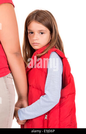 Young girl looking backwards and holding her mother's hand Stock Photo