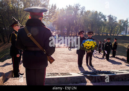 Kiev, Ukraine. 28th October, 2014. Cadets laying flowers to the monument.  Kiev cadets and schoolchildren at Babi Yar, held a rally on the 70th anniversary of Ukraine's liberation. Babii Yar tragedy known worldwide. During the Second World War, the Nazis executed here 100 thousand inhabitants of Kiev, mainly Jews. Celebration of Ukraine's liberation from the Nazis passed under the Russian occupation of the Crimea and Eastern Ukraine. Credit:  Igor Golovnov/Alamy Live News Stock Photo