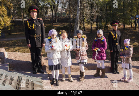 Schoolgirls lay the lamps to the monument. 28th Oct, 2014. -- In Tuesday, October 28, 2014 Kiev cadets and schoolchildren at Babi Yar, held a rally on the 70th anniversary of Ukraine's liberation. Babii Yar tragedy known worldwide. During the Second World War, the Nazis executed here 100 thousand inhabitants of Kiev, mainly Jews. Celebration of Ukraine's liberation from the Nazis passed under the Russian occupation of the Crimea and Eastern Ukraine. © Igor Golovniov/ZUMA Wire/Alamy Live News Stock Photo