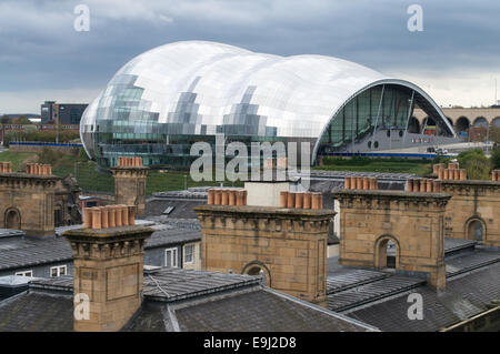 The Sage concert hall in Gateshead seen across a row of chimney pots north east England UK Stock Photo