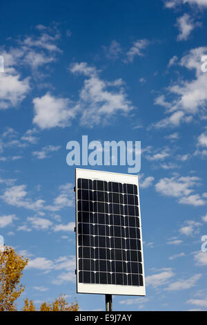 medium sized solar panel against blue cloudy sky on sunny day Stock Photo