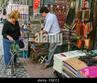 Istanbul, Turkey. 2nd Oct, 2004. A salesman shows his wares to a female tourist in his shop just outside the Grand Bazaar in Istanbul, Turkey. © Arnold Drapkin/ZUMA Wire/Alamy Live News Stock Photo